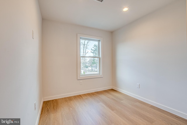 empty room featuring recessed lighting, light wood-style flooring, and baseboards