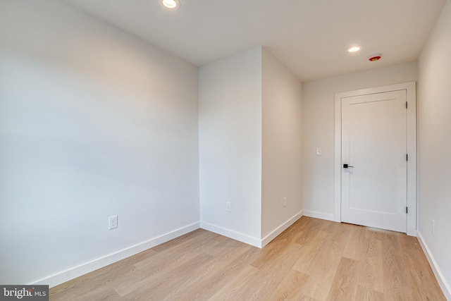 unfurnished room with recessed lighting, baseboards, and light wood finished floors