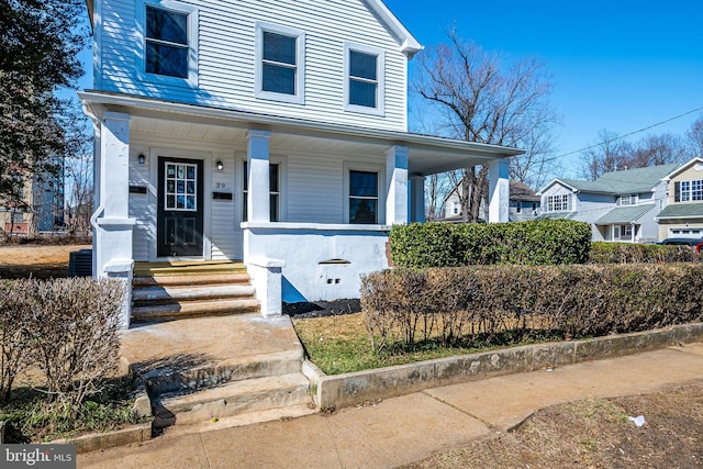 view of front of house with central AC unit and a porch