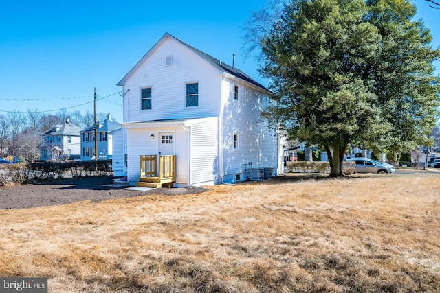 rear view of property featuring central air condition unit