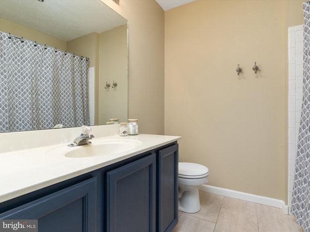 full bathroom featuring vanity, toilet, baseboards, and tile patterned flooring