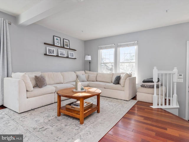 living area featuring hardwood / wood-style floors and beamed ceiling