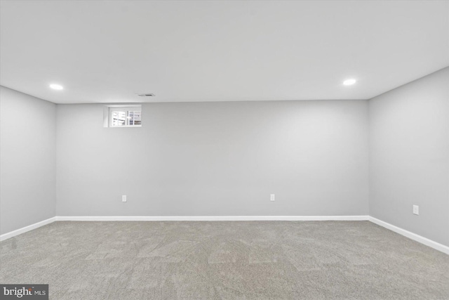 below grade area featuring carpet, visible vents, baseboards, and recessed lighting