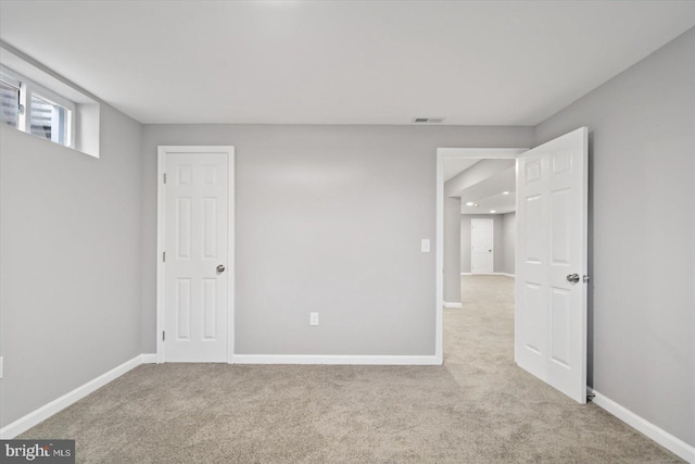 unfurnished bedroom featuring carpet floors, baseboards, and visible vents