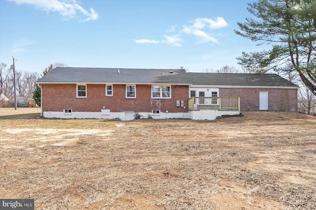 back of property featuring brick siding