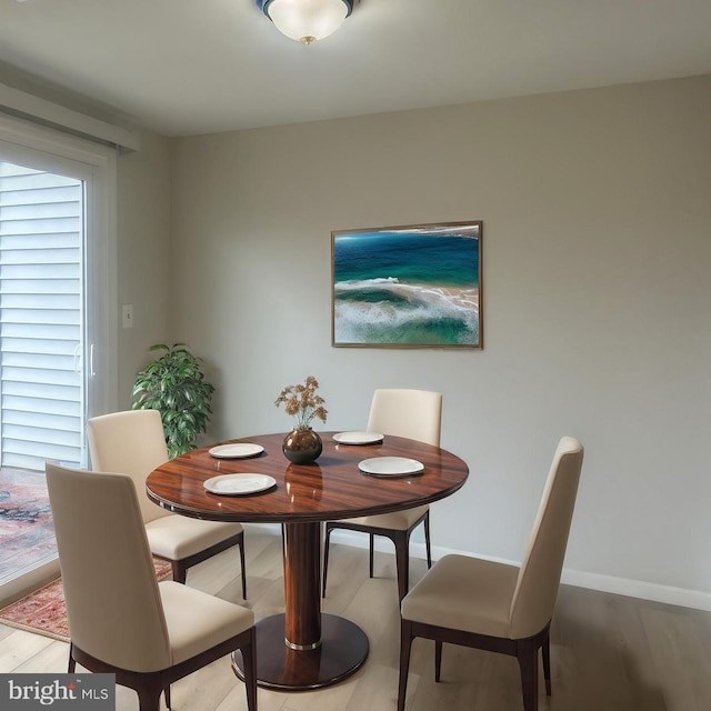 dining space with wood finished floors and baseboards