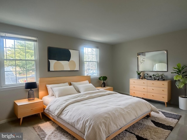 bedroom featuring multiple windows and baseboards