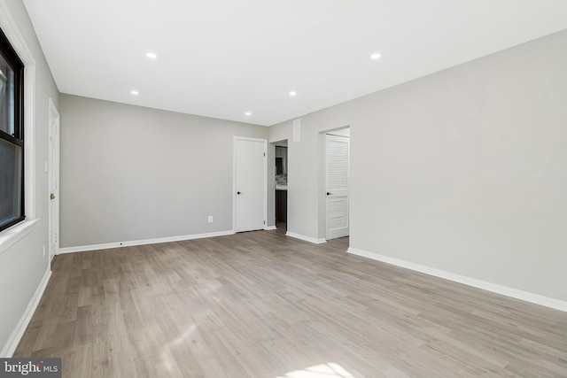 interior space featuring light wood-type flooring, baseboards, and recessed lighting