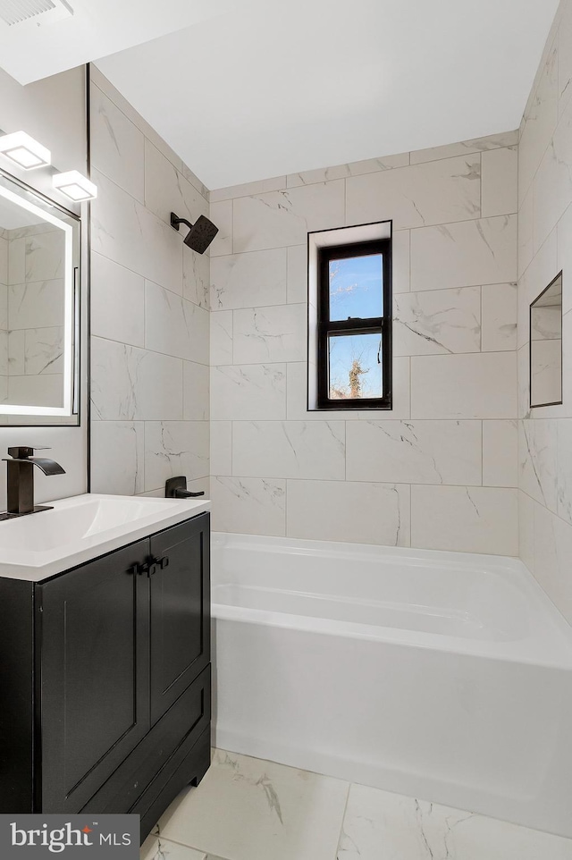 bathroom with marble finish floor, shower / washtub combination, and vanity