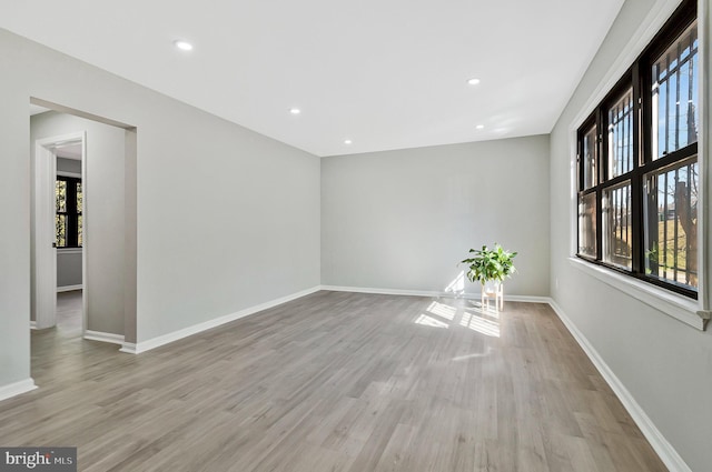 spare room with light wood-style flooring, baseboards, and recessed lighting