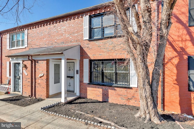 view of property featuring brick siding