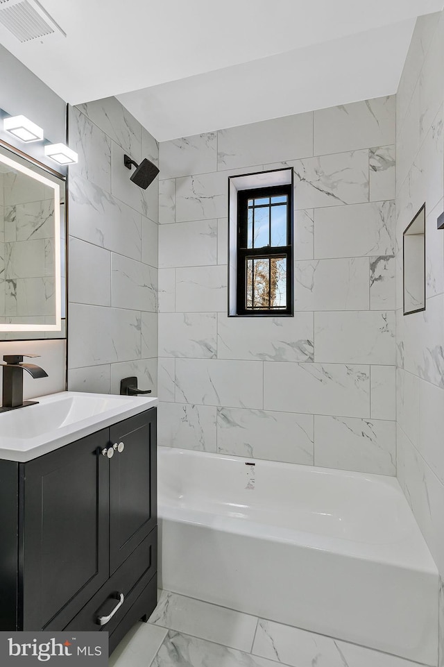 bathroom featuring marble finish floor, visible vents, shower / washtub combination, and vanity