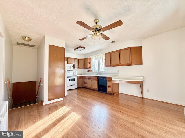 kitchen with light wood finished floors, visible vents, white appliances, and light countertops