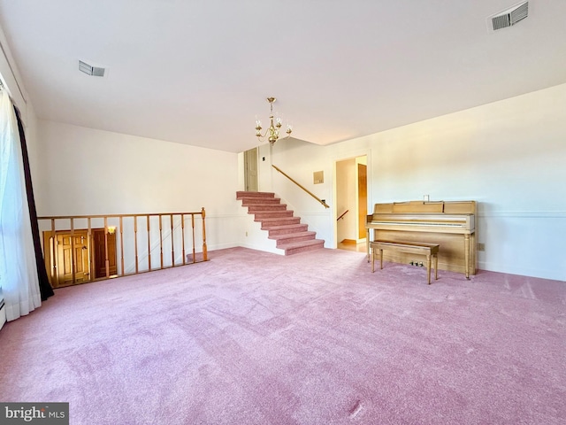 unfurnished room with a chandelier, visible vents, and carpet floors