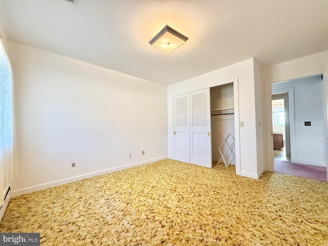 unfurnished bedroom featuring a closet, baseboards, and carpet floors