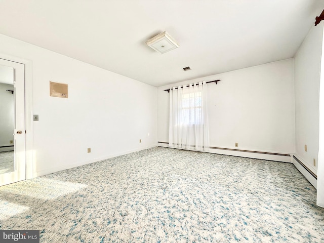 empty room with carpet flooring, visible vents, baseboards, and a baseboard radiator