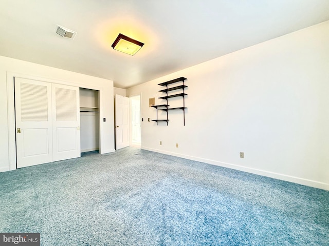 unfurnished bedroom featuring baseboards, visible vents, carpet floors, and a closet