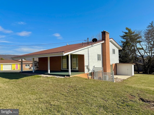 back of property featuring a patio, a lawn, and a chimney