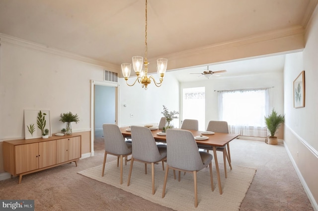 dining room featuring light carpet, baseboards, visible vents, crown molding, and a notable chandelier