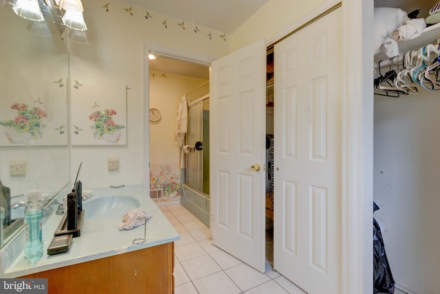 bathroom with tile patterned flooring, vanity, and a chandelier