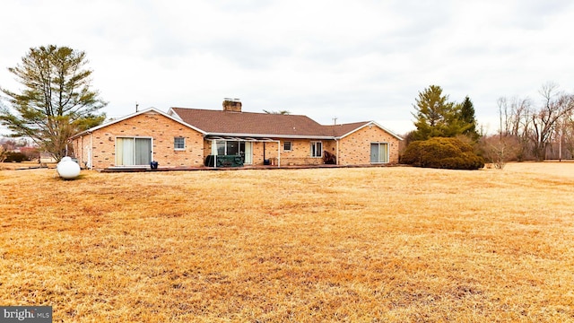 view of front facade featuring a front lawn and a chimney