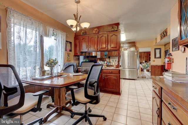 interior space with light tile patterned floors, a chandelier, and wainscoting