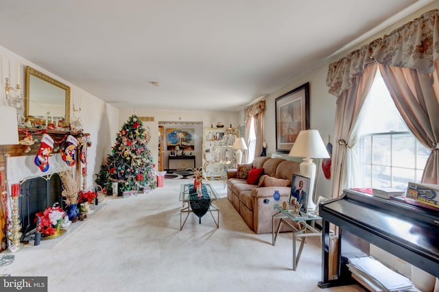 living room featuring a fireplace with flush hearth, carpet flooring, and visible vents