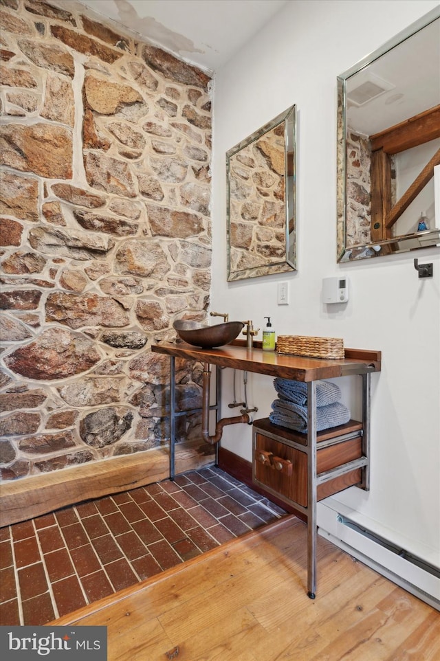 room details featuring a baseboard radiator and wood finished floors