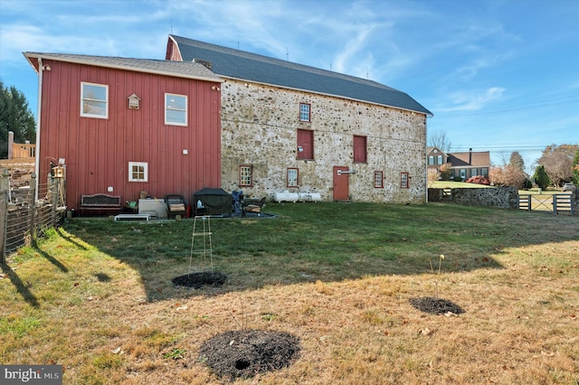 exterior space with fence and a lawn