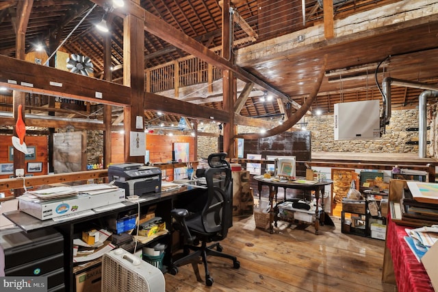 office with wood-type flooring and a high ceiling