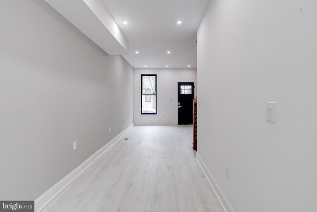 corridor with recessed lighting, light wood-style flooring, and baseboards