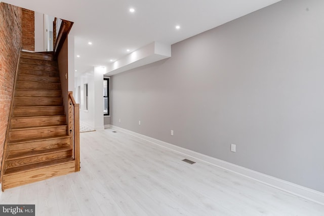 below grade area with stairway, light wood-type flooring, visible vents, and recessed lighting