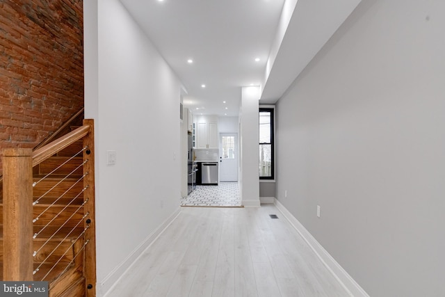 corridor featuring baseboards, recessed lighting, visible vents, and light wood-style floors