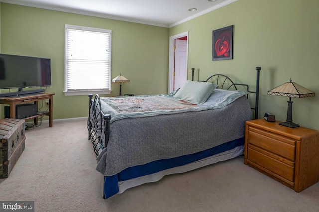 bedroom featuring ornamental molding, light carpet, and baseboards