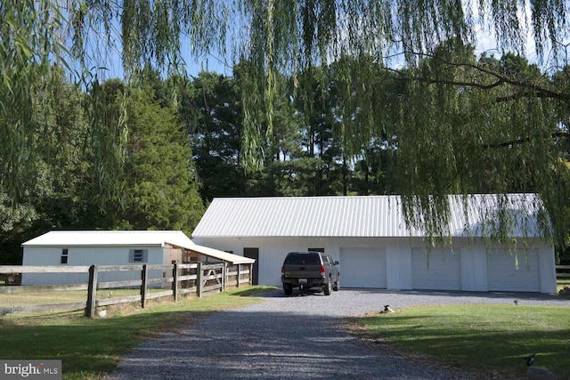 garage with a detached garage and fence