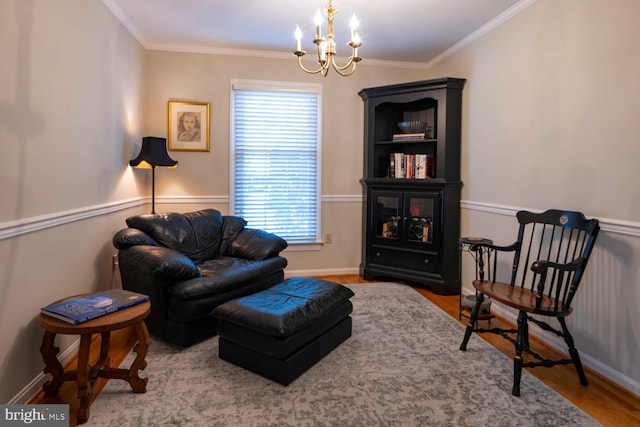 sitting room with baseboards, a chandelier, wood finished floors, and ornamental molding