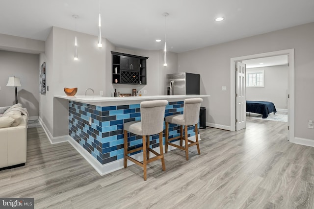 7911 Fort Hunt Rd, Alexandria, VA 22308 - indoor wet bar featuring light wood-style floors, baseboards, recessed lighting, decorative light fixtures, and stainless steel refrigerator with ice dispenser