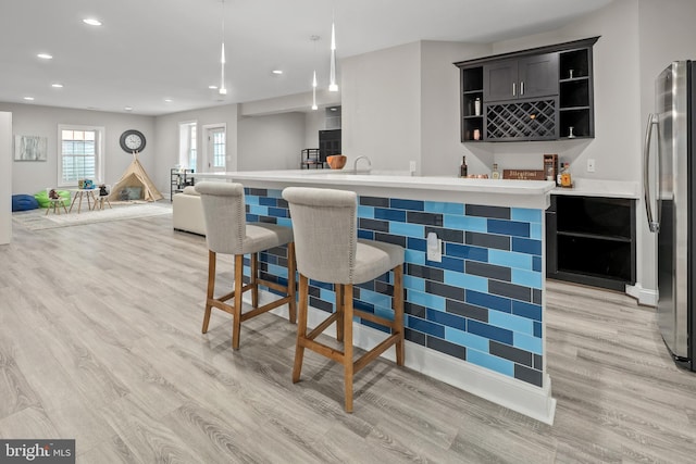 7911 Fort Hunt Rd, Alexandria, VA 22308 - indoor wet bar featuring freestanding refrigerator, light wood-style floors, recessed lighting, baseboards, and decorative light fixtures