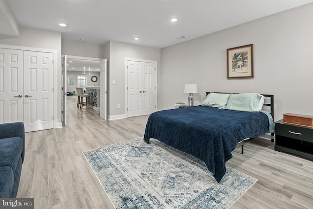 7911 Fort Hunt Rd, Alexandria, VA 22308 - bedroom featuring multiple closets, light wood finished floors, recessed lighting, and baseboards