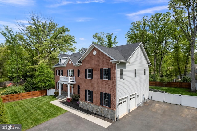 7911 Fort Hunt Rd, Alexandria, VA 22308 - view of front facade with driveway, a balcony, an attached garage, stone siding, and a gate