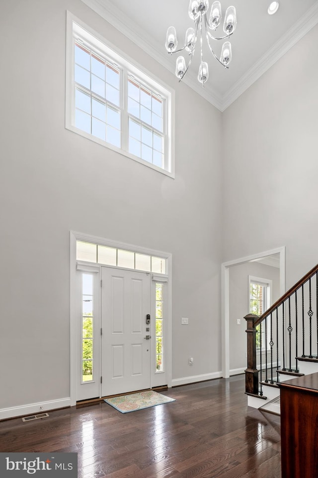 7911 Fort Hunt Rd, Alexandria, VA 22308 - foyer featuring healthy amount of natural light, a chandelier, stairway, dark wood-style flooring, and a towering ceiling