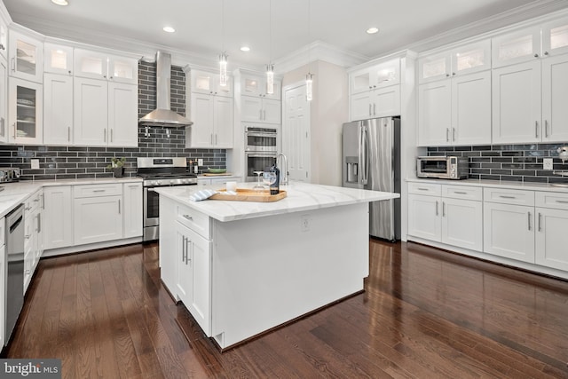 7911 Fort Hunt Rd, Alexandria, VA 22308 - kitchen featuring wall chimney exhaust hood, appliances with stainless steel finishes, white cabinetry, backsplash, and recessed lighting