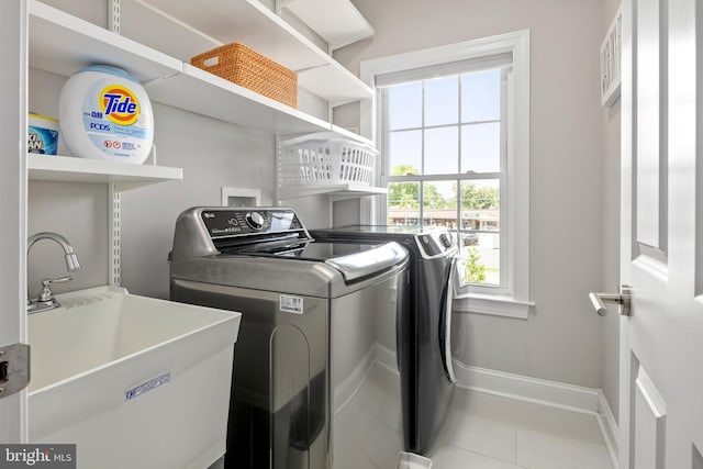 7911 Fort Hunt Rd, Alexandria, VA 22308 - laundry area with washer and clothes dryer, tile patterned flooring, and baseboards