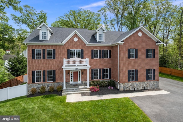 7911 Fort Hunt Rd, Alexandria, VA 22308 - georgian-style home featuring stone siding, brick siding, and a shingled roof