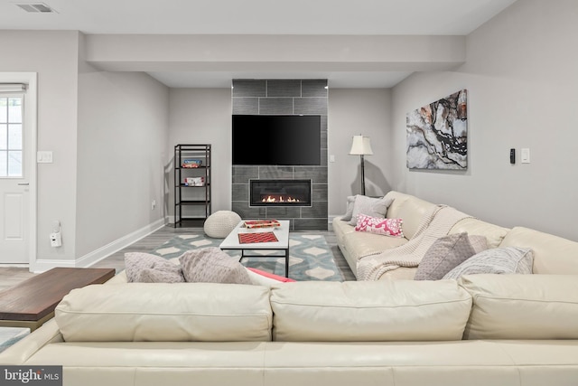 7911 Fort Hunt Rd, Alexandria, VA 22308 - living area featuring wood finished floors, baseboards, and a tiled fireplace