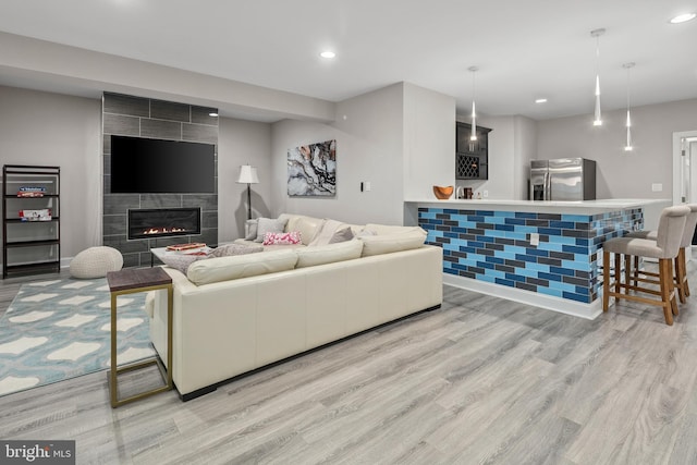 7911 Fort Hunt Rd, Alexandria, VA 22308 - living room with light wood-style flooring, bar area, recessed lighting, a fireplace, and baseboards