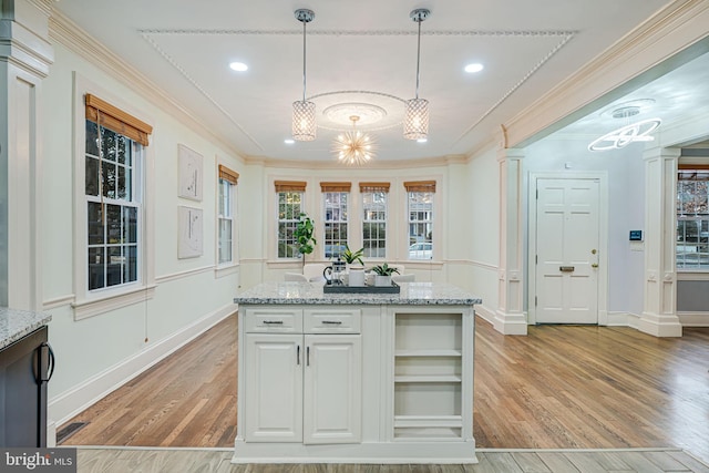 1400 Montague St NW, Washington, DC 20011 - kitchen featuring ornamental molding, pendant lighting, light wood-type flooring, and light stone countertops