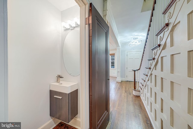 1400 Montague St NW, Washington, DC 20011 - bathroom featuring baseboards, wood-type flooring, vanity, and crown molding