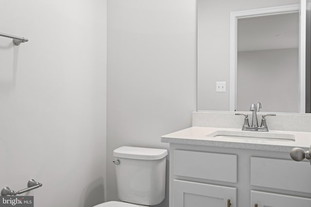 half bathroom with toilet and vanity