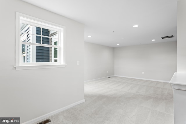 empty room featuring recessed lighting, baseboards, visible vents, and carpet flooring